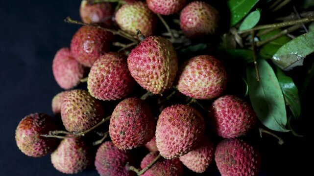 juicy ripe lychees with natural texture and vibrant colors with leafy branches
