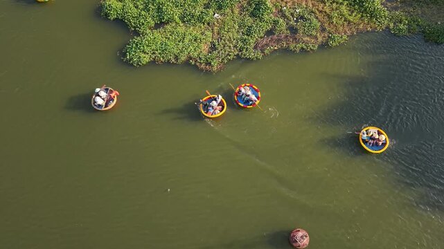 Tour Of Lush Waterways. Group Of Round Boats Gliding Past Verdant Shores. Ecological Tour Featuring Traditional Round Basket Boats Drifting Through Flourishing Green Waterways