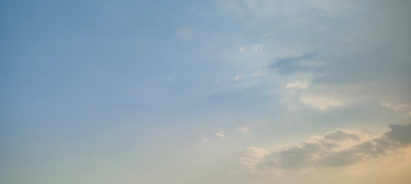 Gradient Pale Blue to Warm Cream Twilight Sky with Soft Shaded Cumulus Cloud Formations