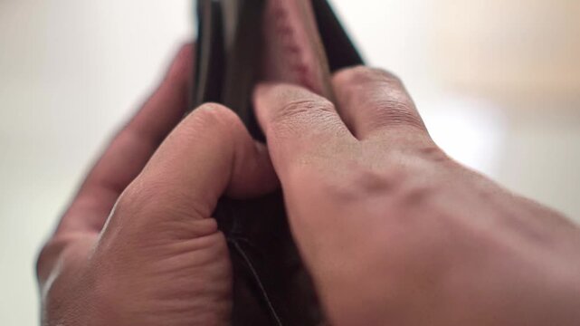 Wallet opened as a hand place paper currency. Financial lifestyle footage showing spending, cash payment, savings, and household budgeting.
