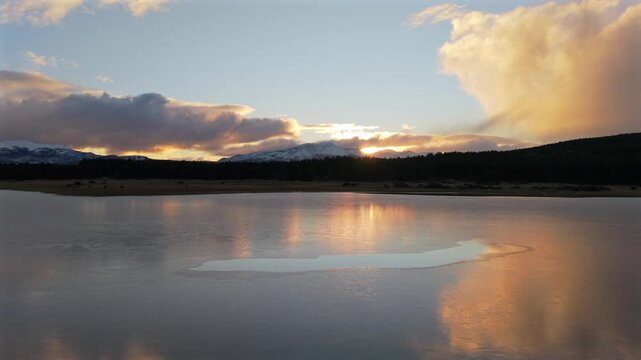 Argentina Patagonia Drone Aerial of Sunset Golden Hour Reflections on La Zeta Lake and Pine Forest Hills in Esquel Chubut