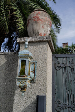 The patina on a larghge and historic lamp on a concrete wall in tropical Florida