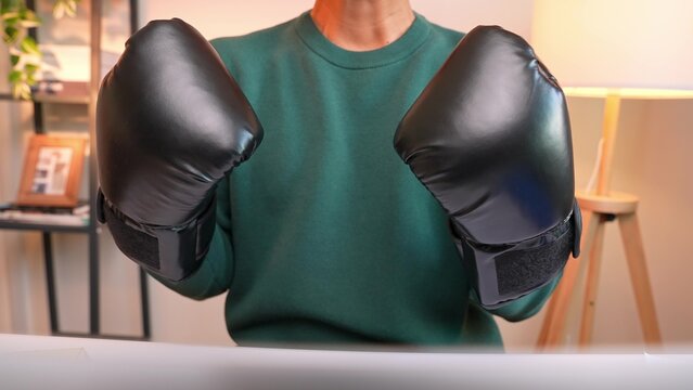 Wearing boxing gloves, this person poses strong and confident, showing mental toughness at work. The image also suggests resilience, self-belief, readiness, motivation, and overcoming challenges.
