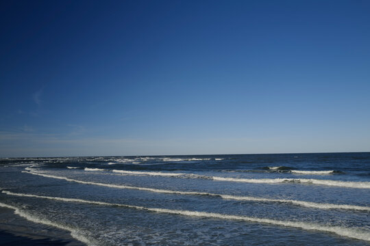 The rough waves and waters of the atlantic ocean meeting the inlet and ouotlet of the Matanzas River near St. Augustine Florida