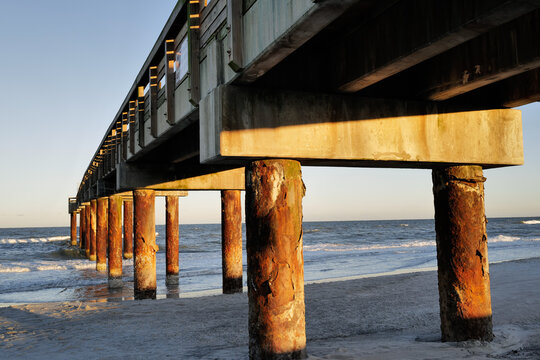 The wooden pier on St. Augustine Beach in Florida at Sunset