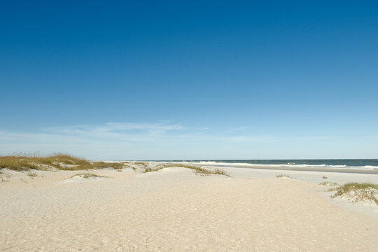 The Wide expanse  of St. Augustine Beach in Florida on a winter day with sand dunes