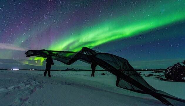 Spectacular Aurora Borealis Display Over Snowy Iceland Landscape with People.