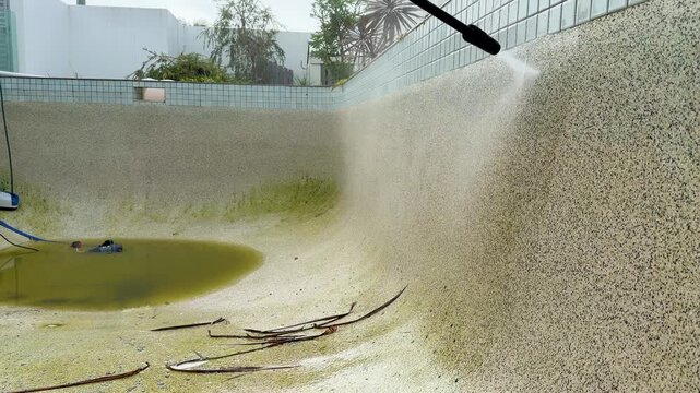 High Pressure Water Blast Cleaning Dirty Concrete Swimming Pool Walls