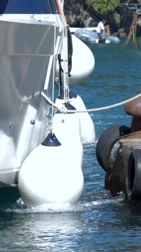Luxury Yacht Docking at a Mediterranean Harbor with White Fenders
