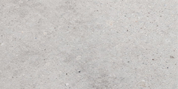 A close-up, high-angle view of a concrete surface reveals its textured and grainy composition, highlighting subtle variations in tone and aggregate distribution.