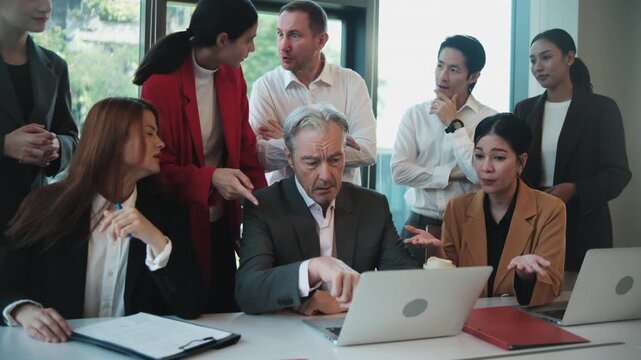 White male senior CEO anxious and tense about company incomes and stock trading investment results on a laptop with multiracial partner team, chaos, and focus on online conference, business meeting.