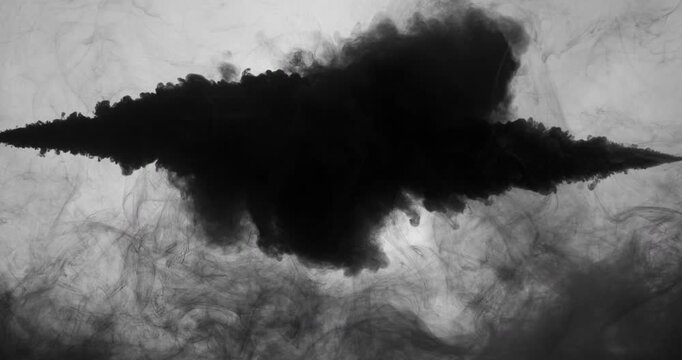 Splash paint mixing, black paint drops mixing in water.
