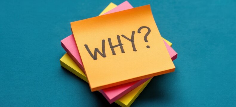 Orange sticky note with "WHY?" question on a stack of colorful notes on a blue background, representing curiosity and inquiry.