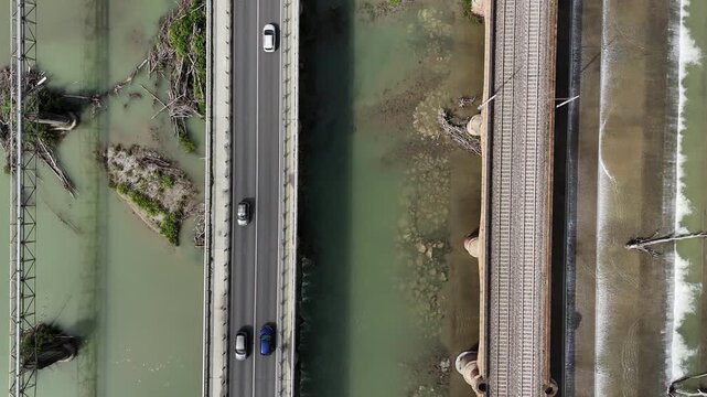 Road and railway bridges crossing the Trebbia River near Piacenza, Emilia-Romagna, Italy, showing river channels, hydraulic infrastructure and transport corridors within the Po Valley, top down reveal