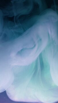 Vertical video. Smoke texture. Fog paint. Blur blue purple yellow colorful rainbow swirling shimmer cloud water spreading on abstract background.