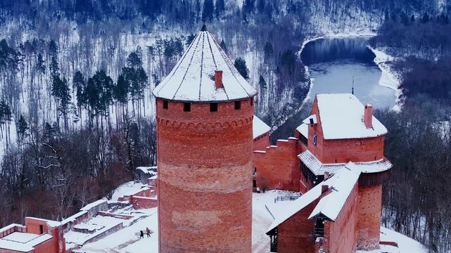 Historic Baltic landmark dominates snowy landscape with timeless grandeur