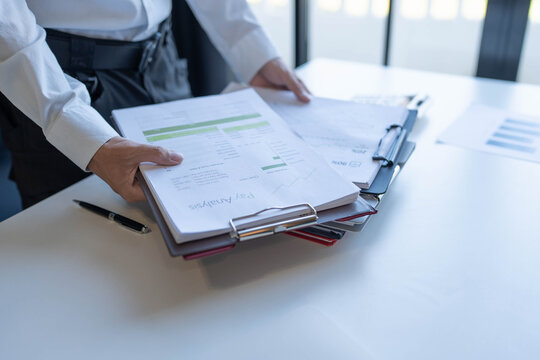 Businessman holding a lot of documents paper work concept