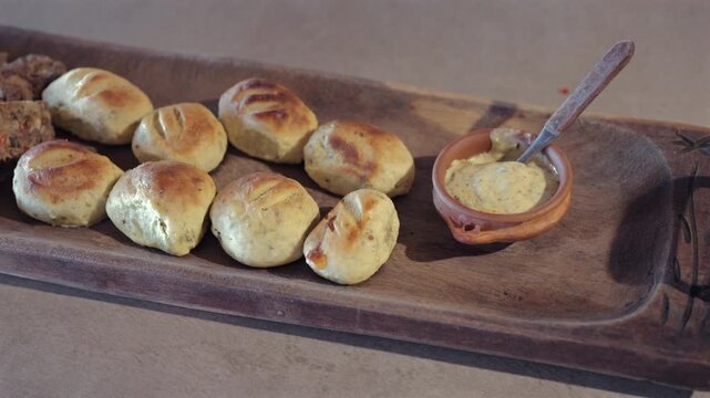 Argentine Bread Rolls Platter Dipping Sauce Bowl Wooden Tray Appatizer Close Up View