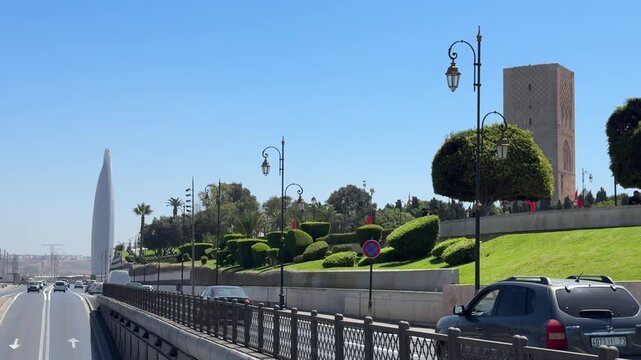 Roadside view of landscaped gardens, historic city walls and Mohammed VI Tower, showcasing urban design, heritage and modern development in Rabat, Morocco