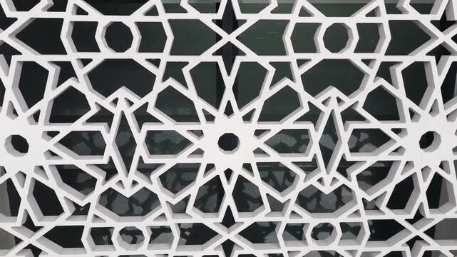 An Islamic geometric pattern serves as a ventilation wall on a building. Made from GFRC, the perforated screen allows airflow while maintaining interior privacy. It combines beauty and function.