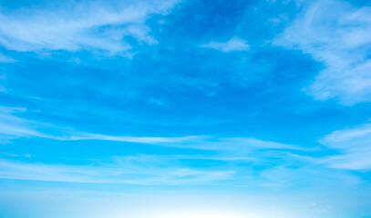 Obraz premium A bright, clear blue sky meets a glowing white horizon, suggesting a serene, open, and with sunlight of beautiful cloudy sky. landscape or abstract background