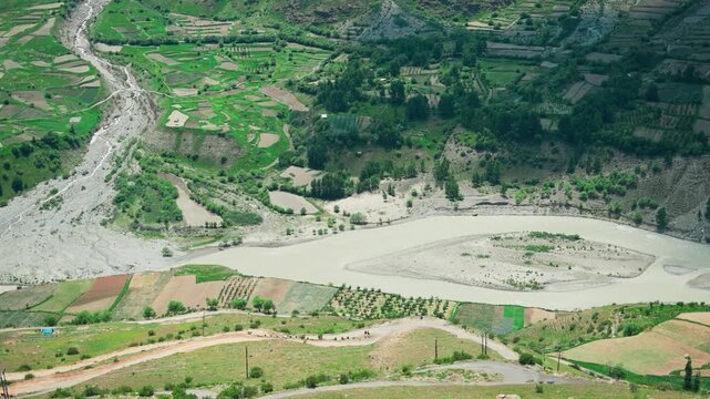 4K Landscape shot of Chenab river flowing in the mountain valley during the summer season as seen from Marbal village in Lahaul and Spiti district, Himachal Pradesh, India. Chenab river in Himalayas.