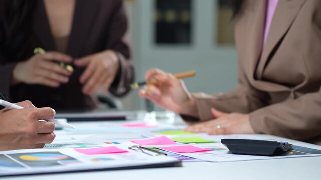 Business consultants discuss tax, merger strategy and restructuring in modern office.