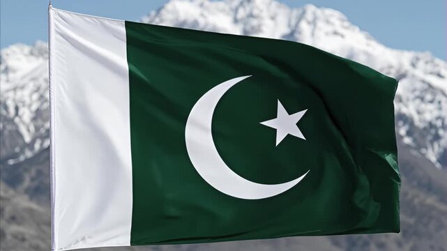 Pakistan flag waves proudly against backdrop majestic snow-capped mountain range clear blue sky, symbolizing national pride sovereignty. August 14th is Pakistan's Independence Day.