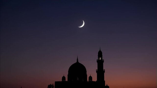 Silhouette Islamic mosque and minaret against vibrant twilight sky with crescent moon, showing beautiful architectural details and peaceful evening atmosphere.