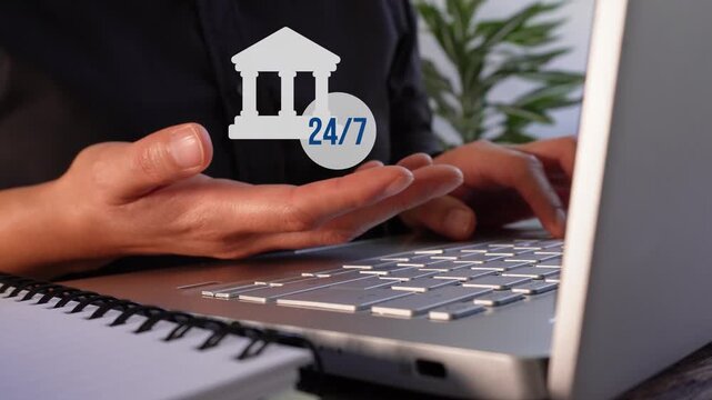 Close-up of a businesswoman's hands working on her laptop while holding an animation of a bank icon with a button that says 24/7. Cash availability 24 hours a day, 7 days a week.