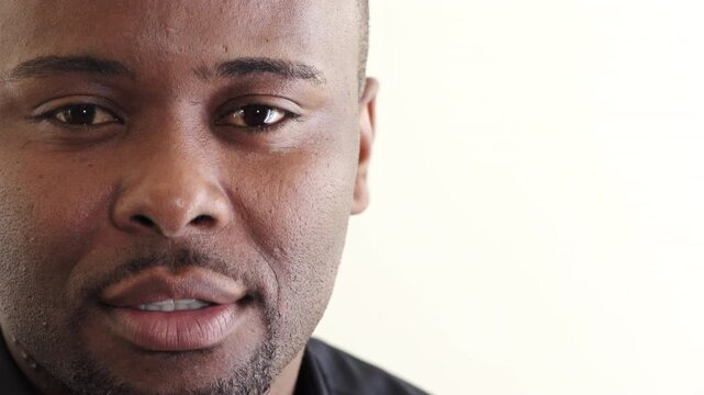 Face, smile and teeth of black man on studio space for dental health or hygiene results. Healthcare, oral care and satisfaction with patient on white background mockup for optometry or wellness