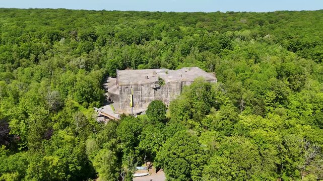 Vertical drone view of V2 rocket and flying bomb displays beside the Blockhaus d'Eperlecques concrete bunker in France.