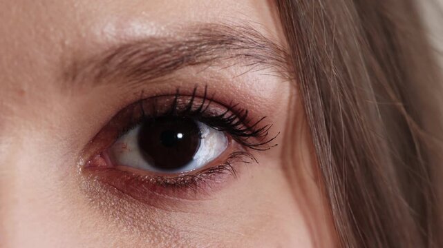 Optometry, face or eye with examination, closeup or glaucoma screening in vision care. Portrait, blink or woman with optical function, eyesight assessment or visual tracking for ocular wellness.