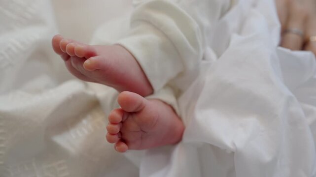 Closeup of newborn baby feet resting on soft white blanket, capturing tenderness, early childhood moments or baptism ceremony