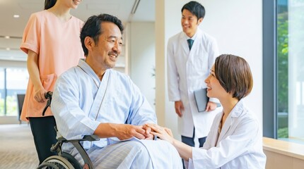 Fototapeta premium Smiling elderly patient in wheelchair holding hands with female doctor, male physician and nurse in background, hospital corridor, healthcare, compassion, recovery, senior care