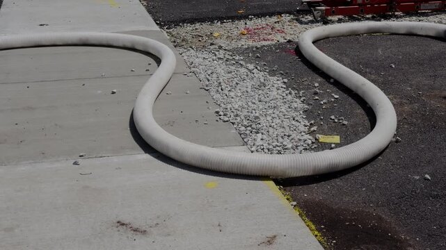 Insulation material being pumped through a hose at a residential construction site for home Insulation installation. Close up