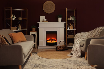 Obraz premium Cozy living room interior with electric fireplace, comfortable sofas, and decorative shelving for home comfort