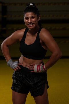 Smiling Female Boxer In Gym Training With Hand Wraps Showing Strength And Confidence