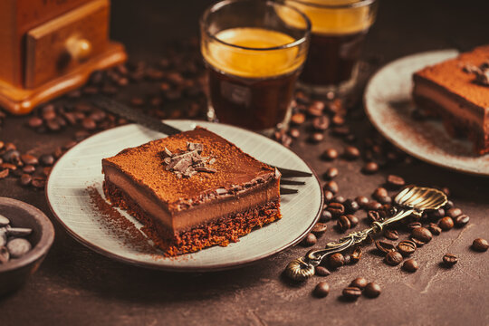 Homemade French layered chocolate cake with two cups of coffee