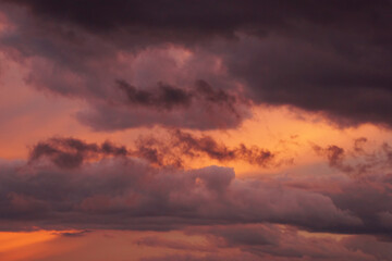Obraz premium Picturesque cloudy summer sunset in orange and blue tones