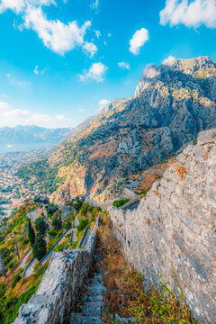 Kotor Bay and the Old Town Kotor from the ancient San Giovanni fortress walls, featuring the Adriatic sea and majestic mountains, Montenegro.