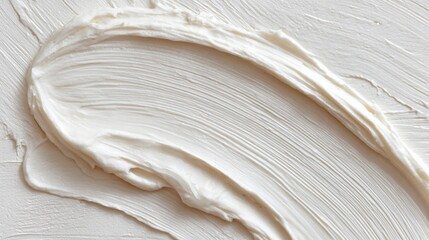 Obraz premium Thick, white, creamy cosmetic texture with visible brush strokes and subtle highlights