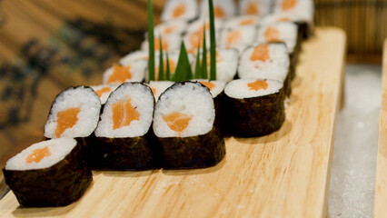 Fresh Salmon Maki Sushi Rolls Arranged on a Wooden Tray © blueringmedia
