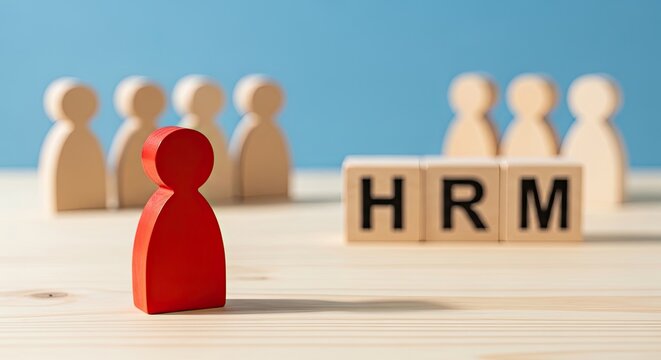 Human Resource Management concept with red and wooden figurines on a desk with HRM blocks