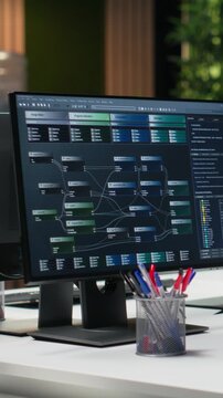 Vertical frame showing computer in Silicon Valley company office automating app development tasks with machine learning.
