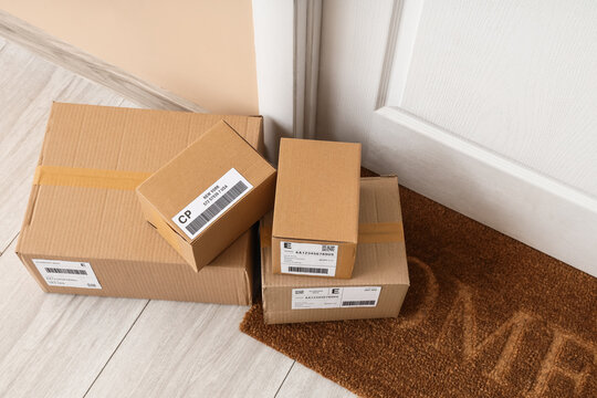 Cardboard delivery boxes with shipping labels on doorstep, e-commerce and logistics concept, online shopping and home delivery service