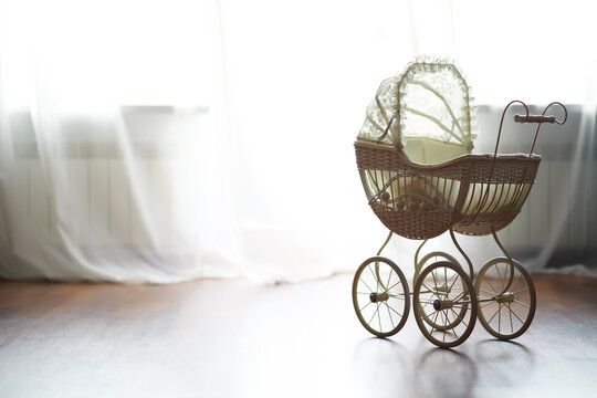 Vintage Baby Carriage by Window with Delicate White Curtains and Natural Light