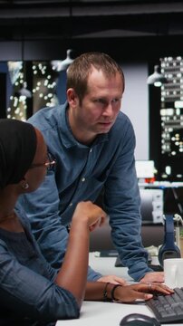 Vertical frame showing manager assisting intern automating mobile app development tasks using AI scripts. Supervisor helps trainee leverage AI to accelerate feature implementation.