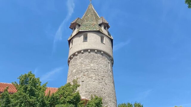 Low angle tilt up view of the historic Gruner Turm tower against blue sky in Ravensburg, Germany