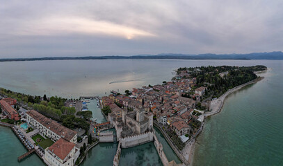 Obraz premium Aerial view over Castello Scaligero di Sirmione in Garda lake, Italy